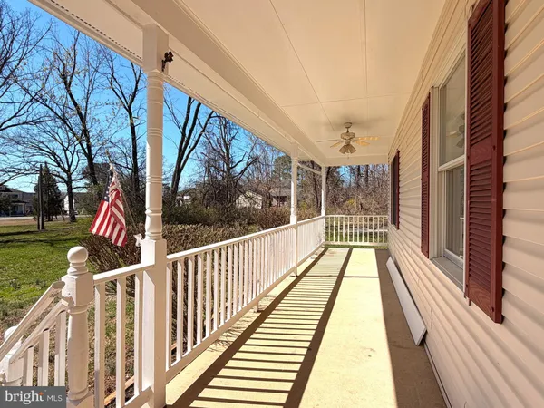 a view of balcony with wooden floor and fence