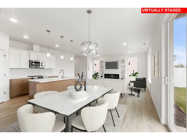 a very nice looking dining room with a large dining table and chairs