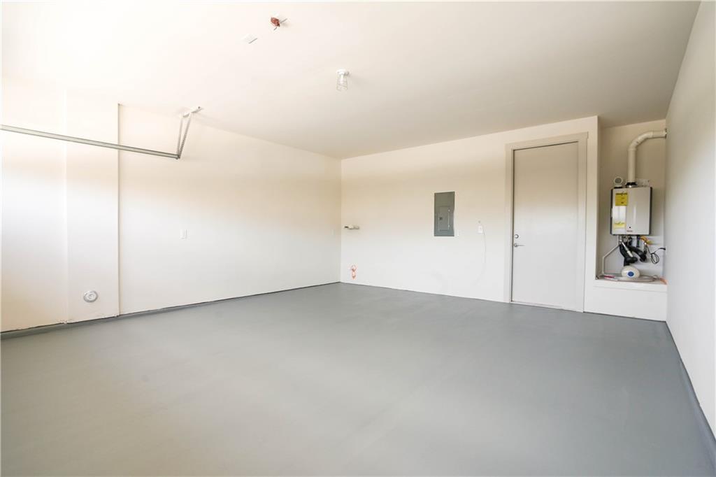 2341 Gabriels Horn Road Leander, TX 78641 - Photo 16 of 20 Garage with water heater and electric panel