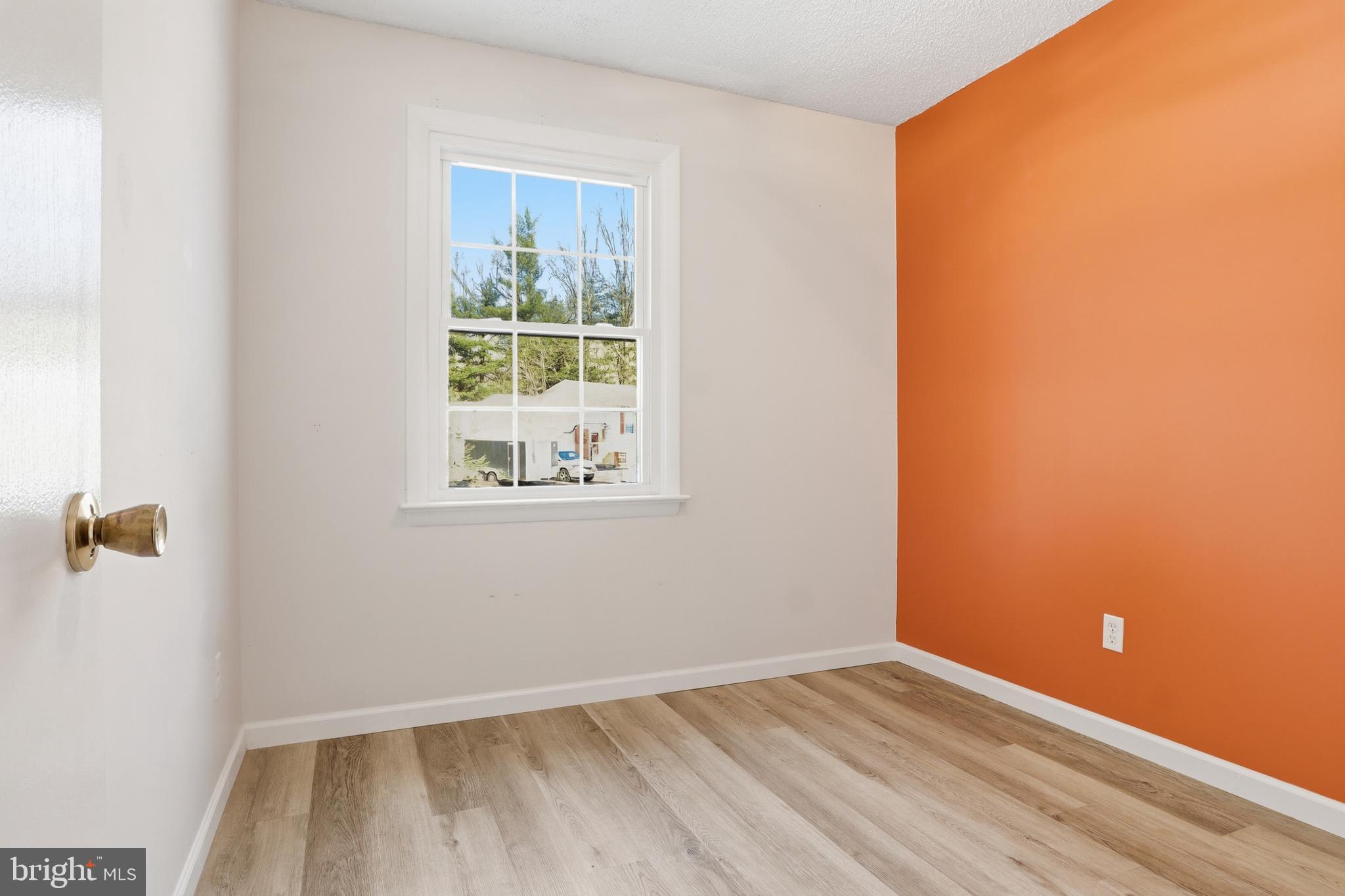 276 Oakbrook Drive Felton, PA 17322 - Photo 18 of 55 a view of an empty room with wooden floor and a window