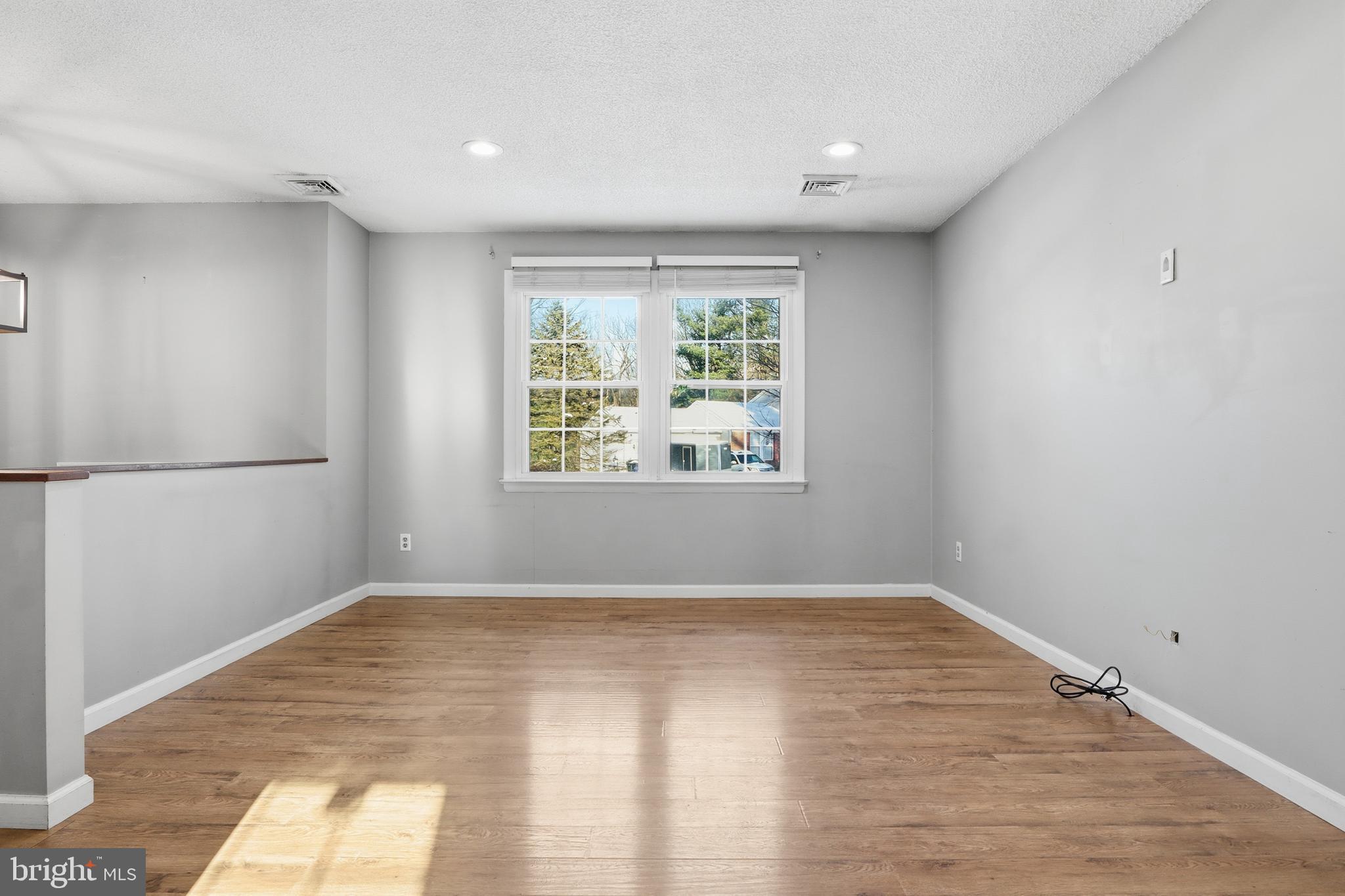 276 Oakbrook Drive Felton, PA 17322 - Photo 5 of 55 a view of an empty room with wooden floor and a window