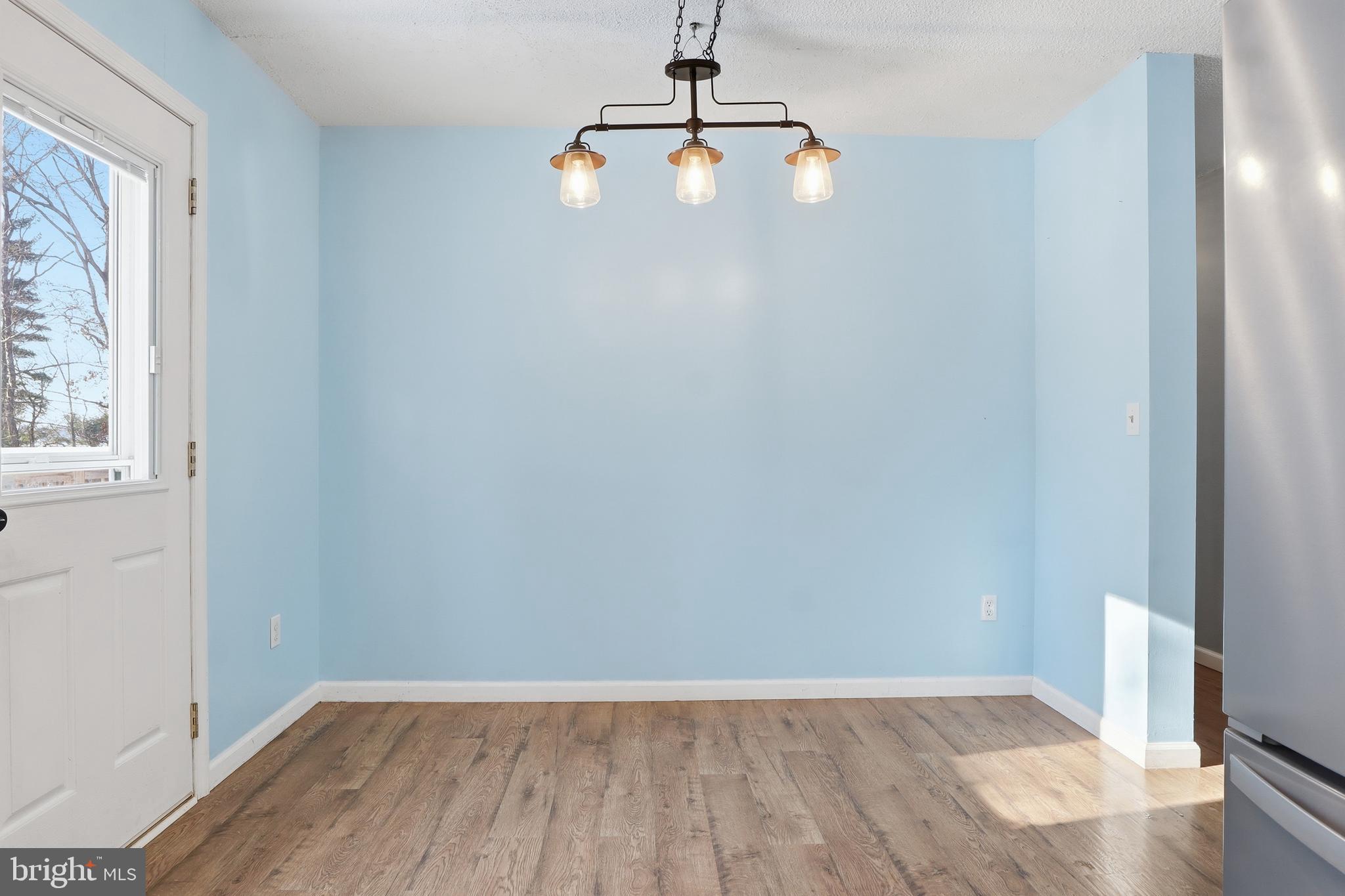 276 Oakbrook Drive Felton, PA 17322 - Photo 10 of 55 a view of an empty room with wooden floor and a window