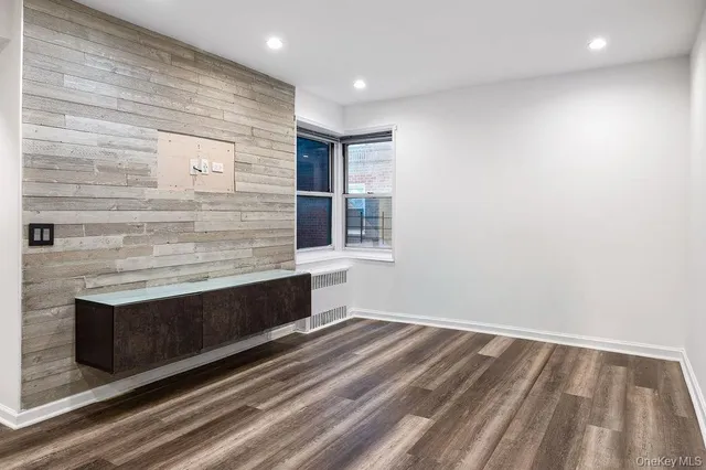a view of room with wooden floor and window