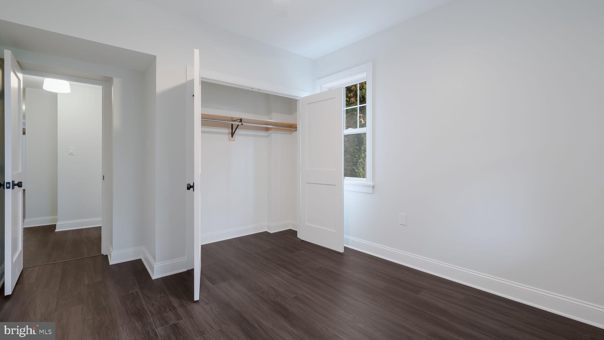 115 Harvey Avenue, Unit 1171 Doylestown, PA 18901 - Photo 22 of 26 a view of an empty room with wooden floor