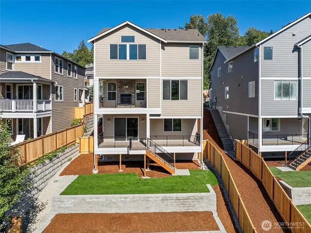a view of a house with wooden deck and a yard