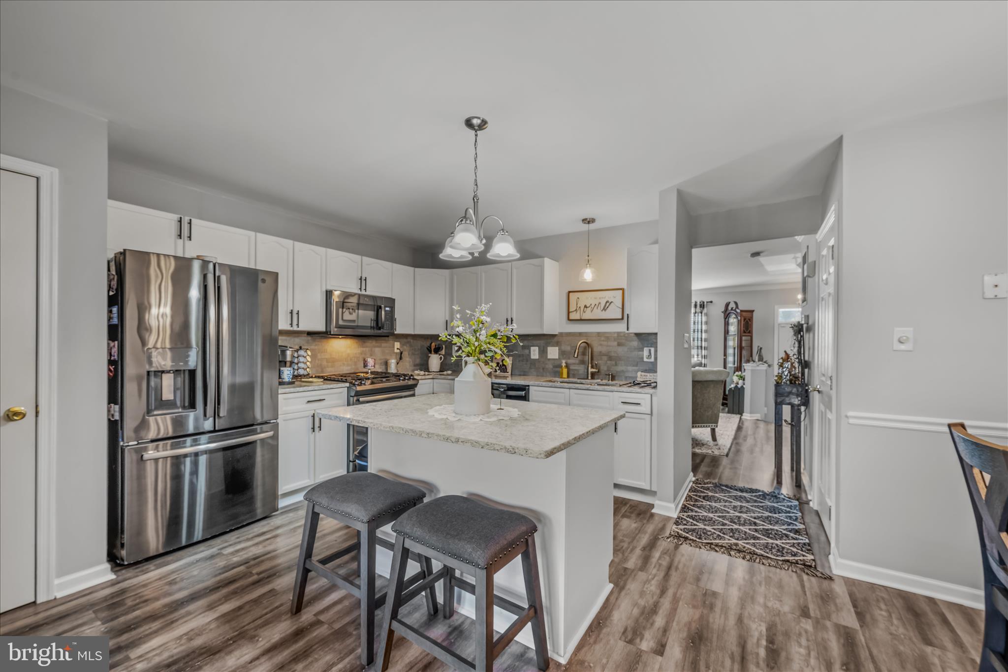 43 Scarboro Drive Bunker Hill, WV 25413 - Photo 9 of 43 a kitchen with refrigerator a sink and wooden floor