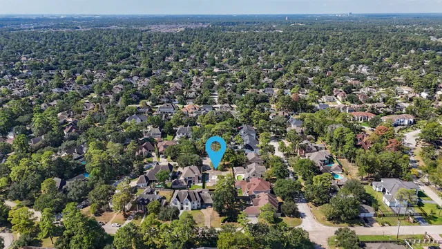 an aerial view of a houses with a yard