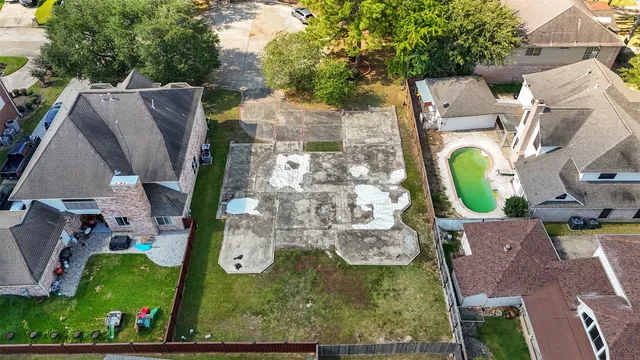an aerial view of residential house with outdoor space and swimming pool