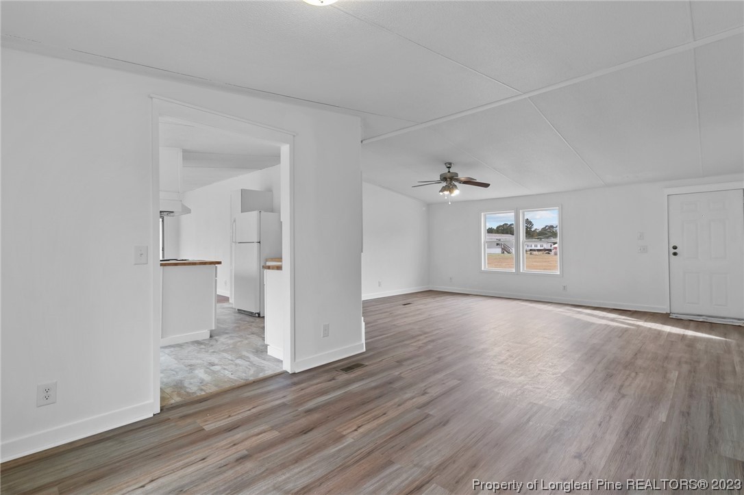 420 Ridge Lane Autryville, NC 28318 - Photo 15 of 39 an empty room with wooden floor cabinet and windows