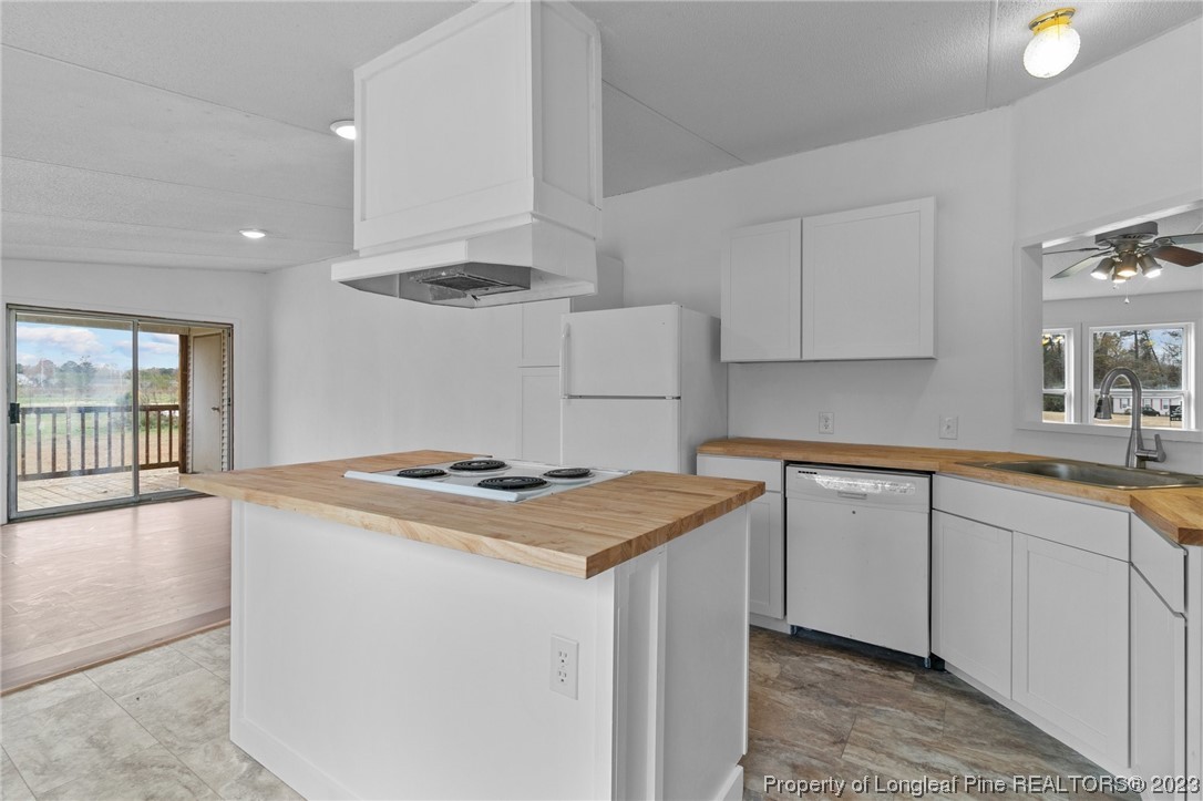 420 Ridge Lane Autryville, NC 28318 - Photo 16 of 39 a kitchen with a stove and a sink