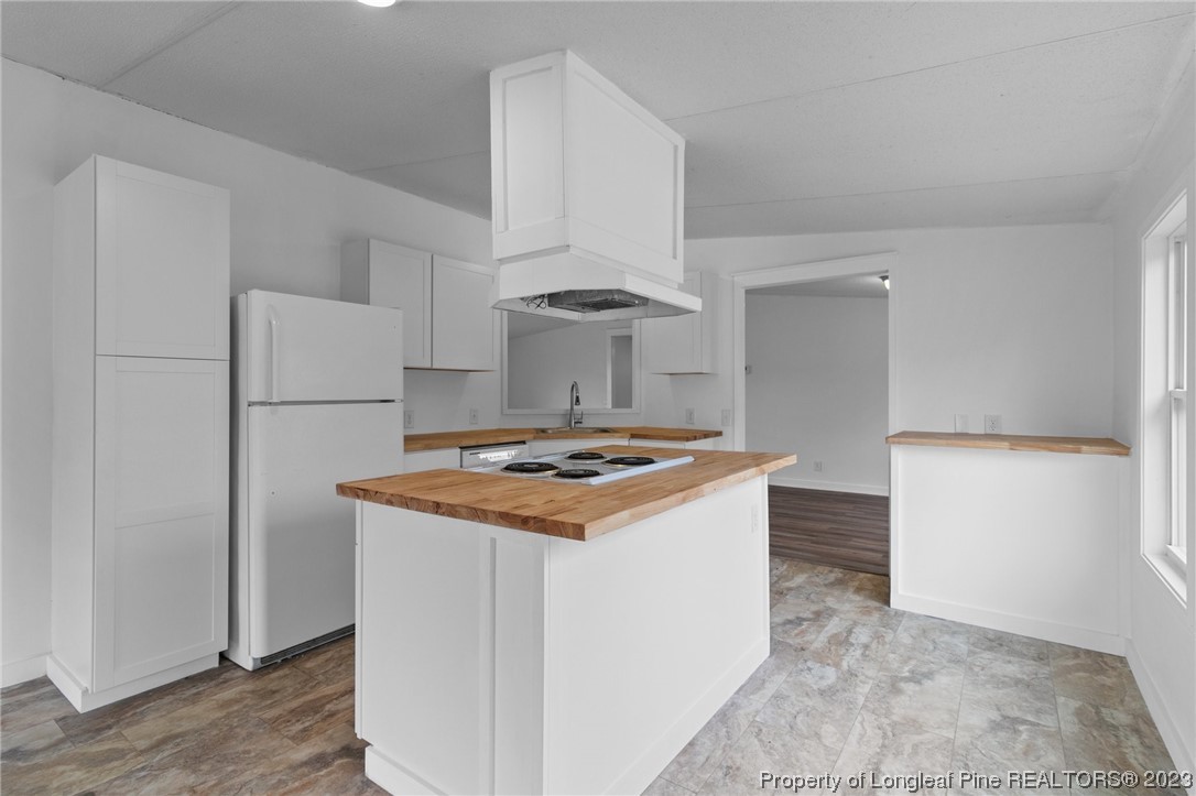 420 Ridge Lane Autryville, NC 28318 - Photo 22 of 39 a kitchen with a stove and a refrigerator