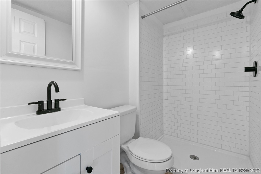 420 Ridge Lane Autryville, NC 28318 - Photo 23 of 39 a bathroom with a sink a toilet and shower