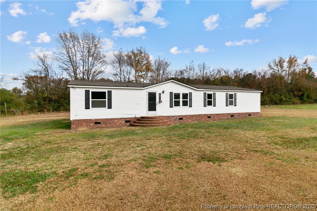 420 Ridge Lane Autryville, NC 28318 - Photo 30 of 39 a view of a house with a backyard