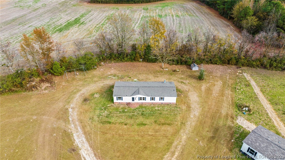 420 Ridge Lane Autryville, NC 28318 - Photo 3 of 39 a building with trees in the background