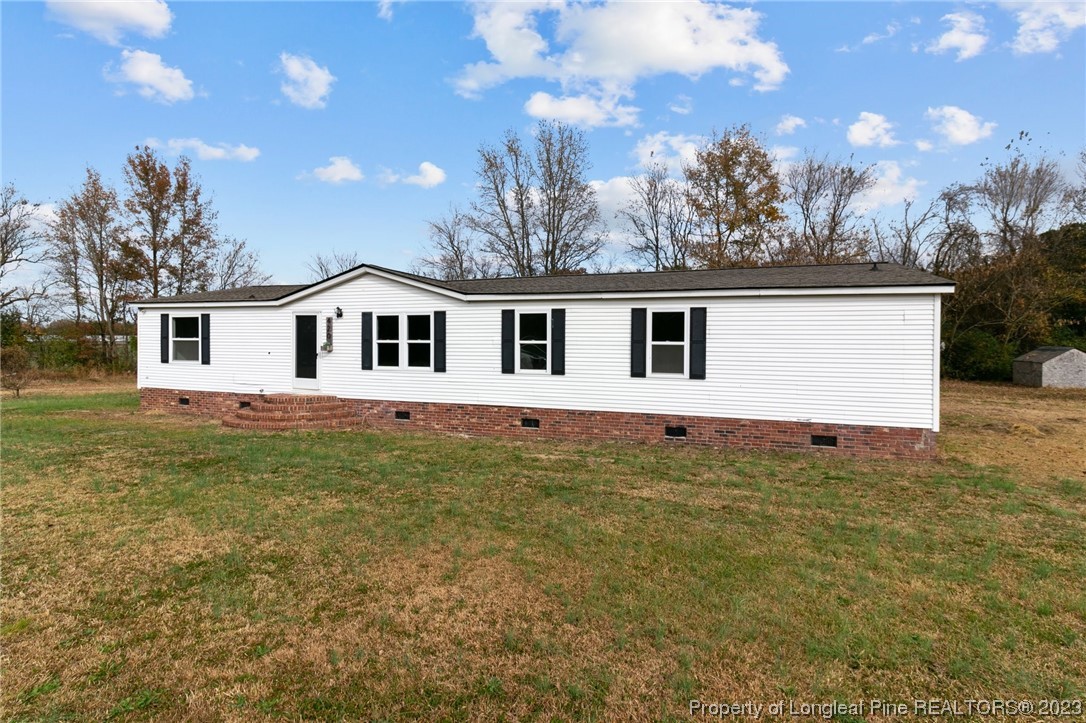 420 Ridge Lane Autryville, NC 28318 - Photo 32 of 39 a view of a house with a backyard