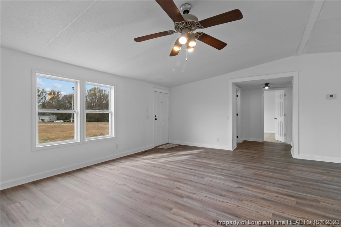 420 Ridge Lane Autryville, NC 28318 - Photo 9 of 39 a view of an empty room with wooden floor and a window