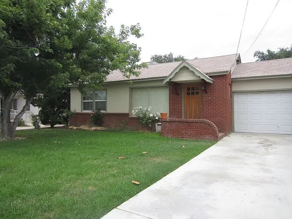 a backyard of a house with table and chairs