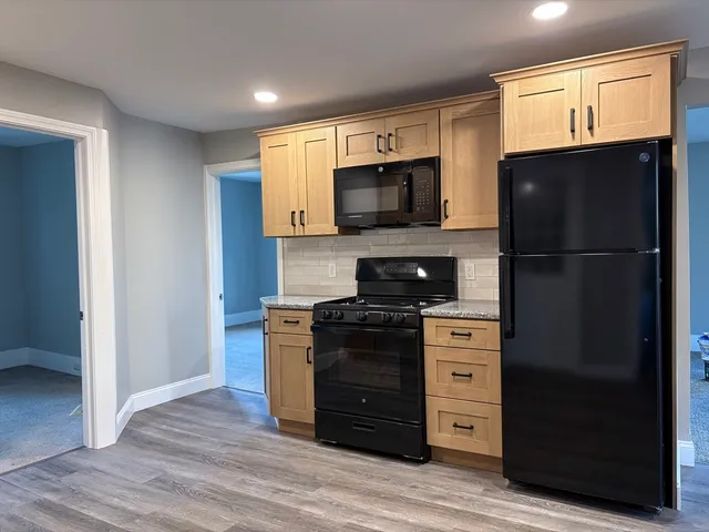 a kitchen with stainless steel appliances a refrigerator stove and sink