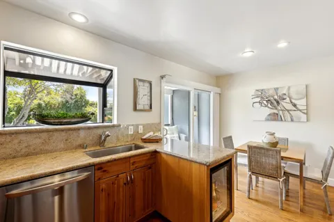 a kitchen with a sink and a large window