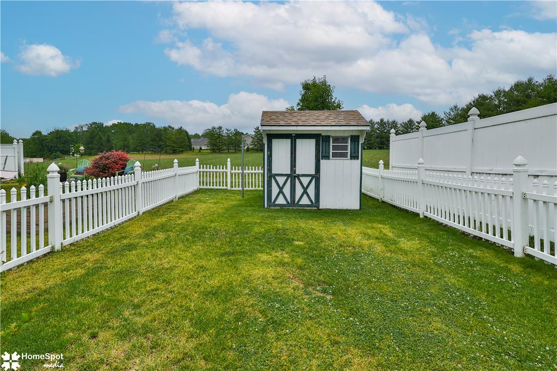 507 Howertown Road Northampton, PA 18067 - Photo 41 of 46 A quaint backyard with a picket fence and shed offers a perfect private outdoor retreat.