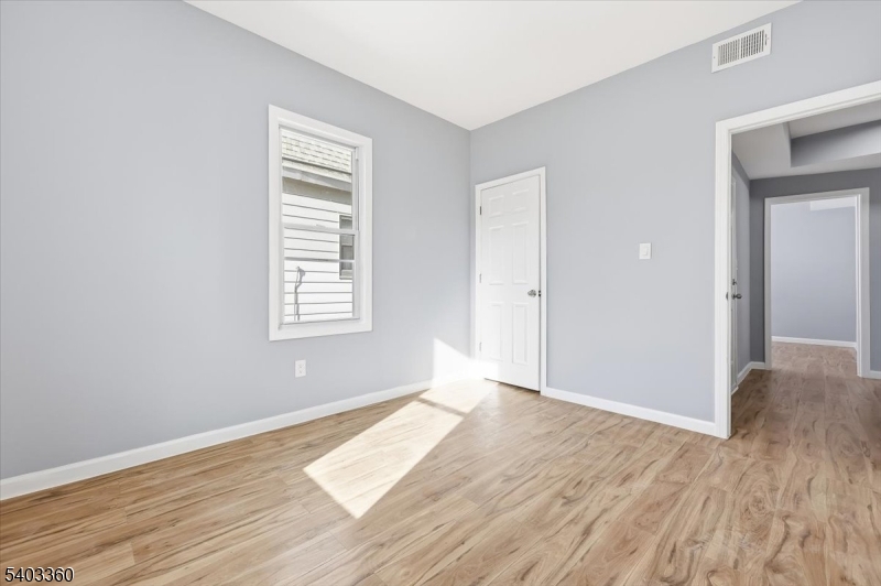 76 Riggs Place, Unit 2 West Orange, NJ 07052 - Photo 15 of 24 an empty room with wooden floor and windows