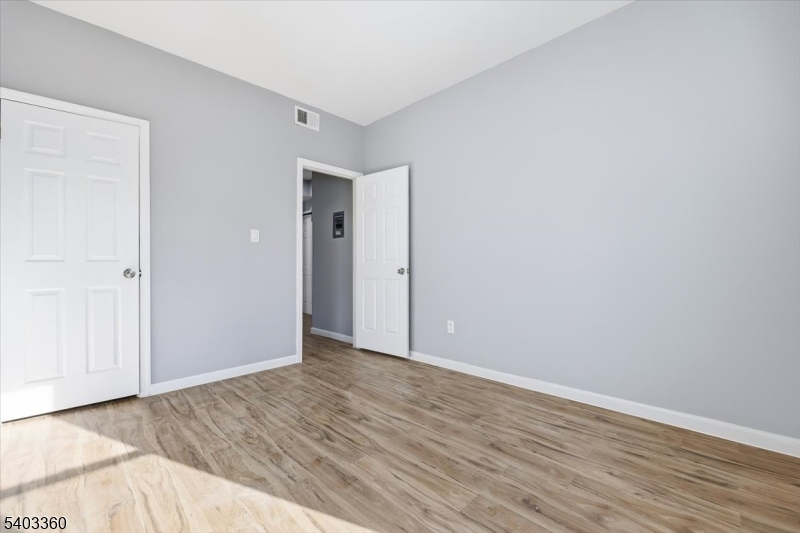 76 Riggs Place, Unit 2 West Orange, NJ 07052 - Photo 16 of 24 a view of an empty room with wooden floor