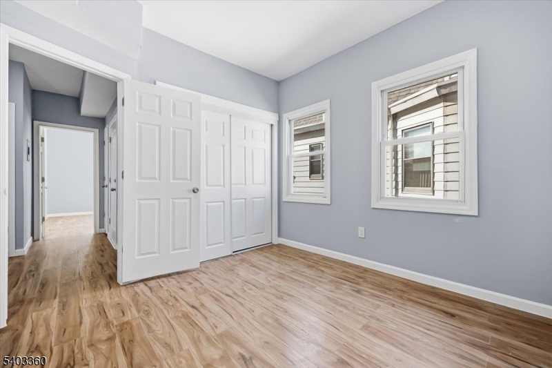 76 Riggs Place, Unit 2 West Orange, NJ 07052 - Photo 18 of 24 a view of an empty room with wooden floor and a window