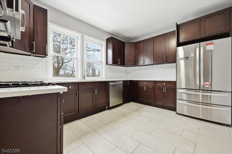 76 Riggs Place, Unit 2 West Orange, NJ 07052 - Photo 2 of 24 a kitchen with a refrigerator and a sink