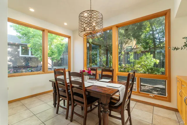 a view of a dining room with furniture large windows and wooden floor