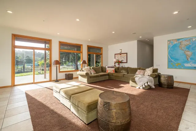 a living room with couch and large windows