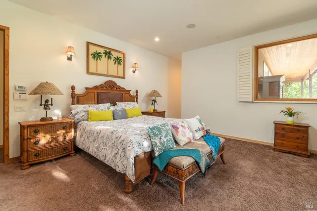 a bed room with a bed and a chair