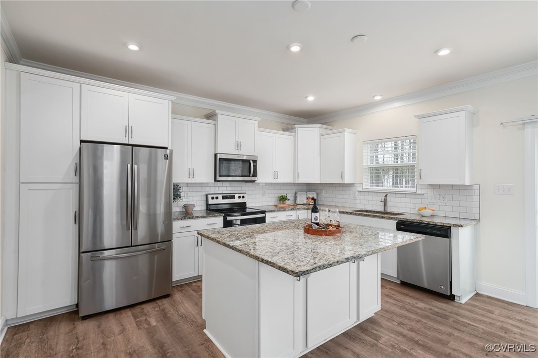 9019 Forge Gate Lane Chesterfield, VA 23832 - Photo 11 of 47 a kitchen with stainless steel appliances a refrigerator a sink a stove a microwave a center island and a center island