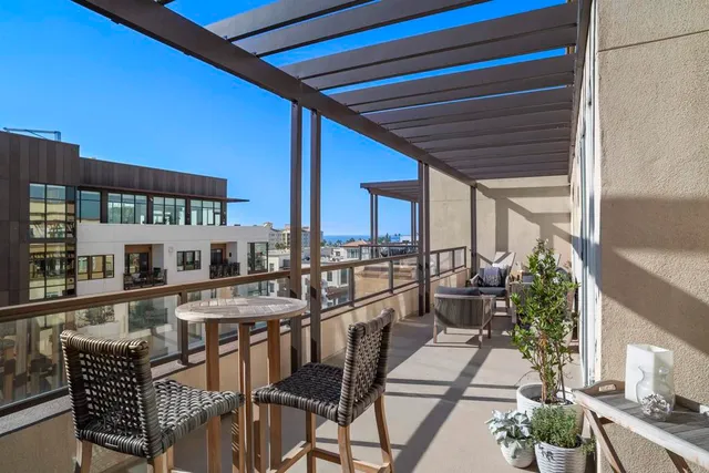 a dining room with furniture and a floor to ceiling window