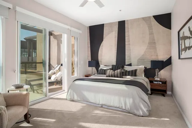 a bedroom with a large bed and a large window