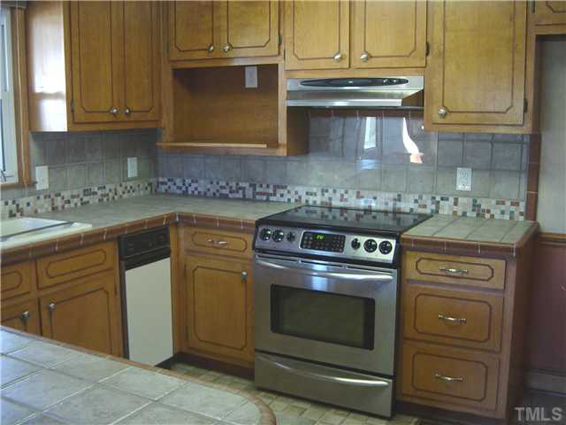 Smooth top range, ceramic tile countertops and backsplash.