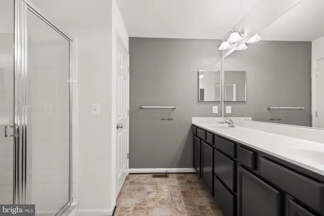 a bathroom with a sink vanity and a mirror