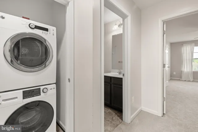 a view of a hallway with washer and dryer
