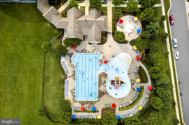 an aerial view of a house with yard swimming pool and lake view