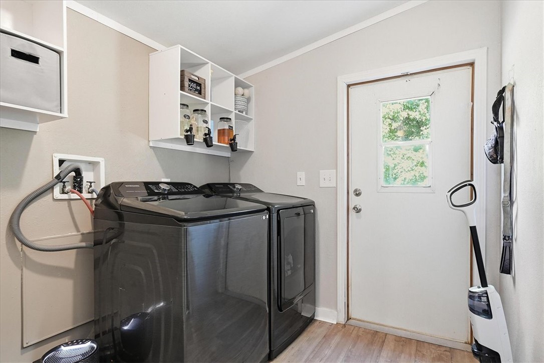1014 Harris Road Anderson, SC 29625 - Photo 22 of 34 Functional laundry space featuring modern appliances and clever wall-mounted shelving for organized storage.