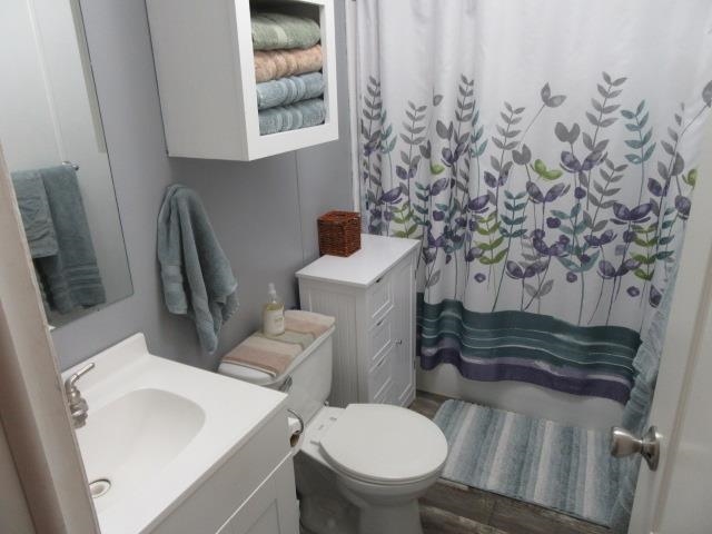 3251 E Road, Unit 99 Clifton, CO 81520 - Photo 23 of 25 a bathroom with a toilet sink and mirror