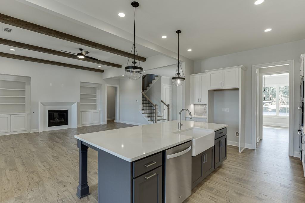 446 Thunder Road Buford, GA 30518 - Photo 13 of 79 a kitchen with a sink center island and stainless steel appliances