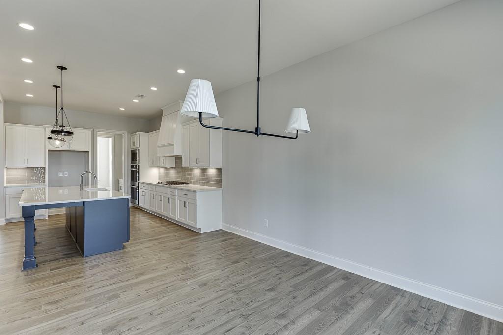 446 Thunder Road Buford, GA 30518 - Photo 16 of 79 a open kitchen with a sink and refrigerator