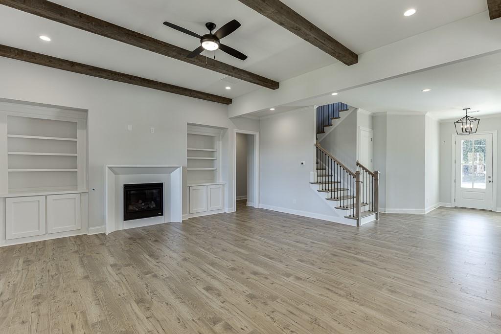 446 Thunder Road Buford, GA 30518 - Photo 18 of 79 a view of an empty room with wooden floor fireplace and a window