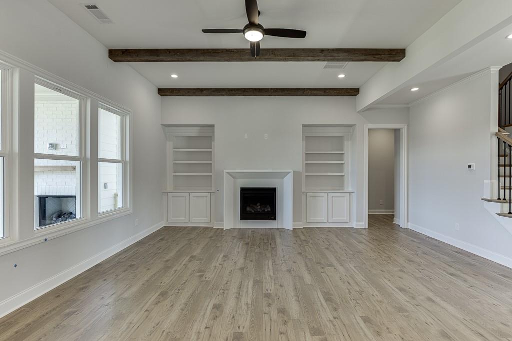 446 Thunder Road Buford, GA 30518 - Photo 19 of 79 wooden floor fireplace and windows in an empty room