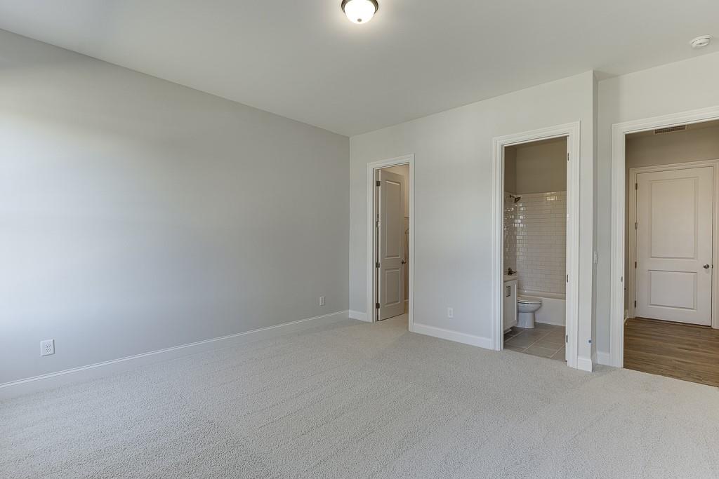 446 Thunder Road Buford, GA 30518 - Photo 25 of 79 an empty room with closet and mirror