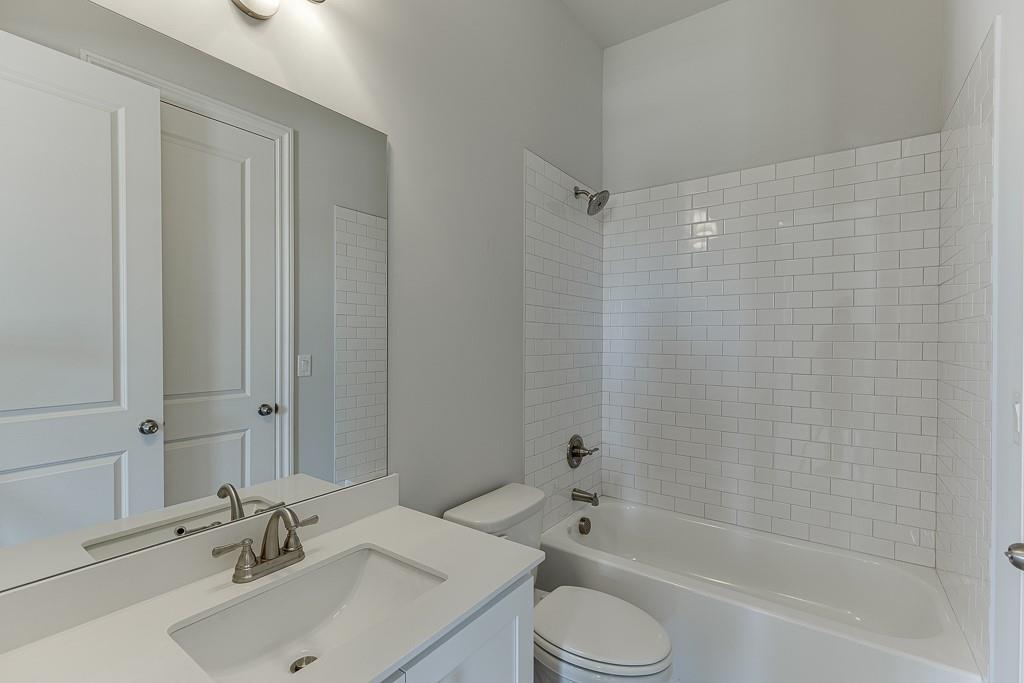 446 Thunder Road Buford, GA 30518 - Photo 26 of 79 a bathroom with a sink toilet and shower