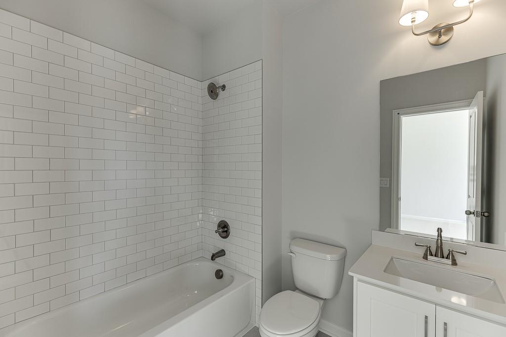 446 Thunder Road Buford, GA 30518 - Photo 34 of 79 a bathroom with a sink a toilet and shower