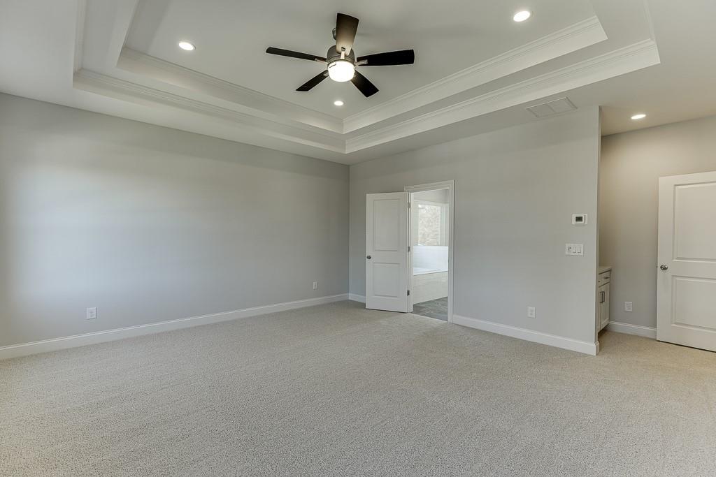 446 Thunder Road Buford, GA 30518 - Photo 40 of 79 en empty room with ceiling fan and window