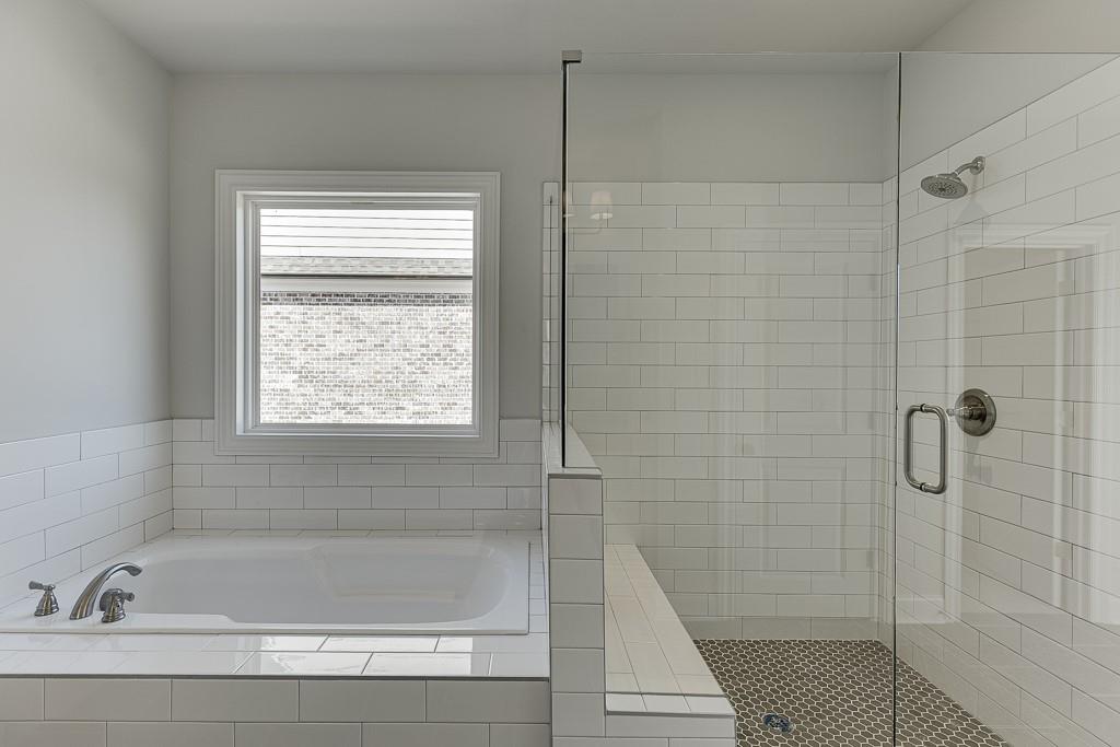 446 Thunder Road Buford, GA 30518 - Photo 43 of 79 a bathroom with a bathtub and shower