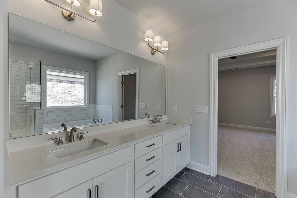 446 Thunder Road Buford, GA 30518 - Photo 44 of 79 a bathroom with a double vanity sink and a mirror